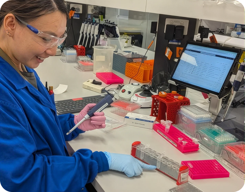 A researcher working with samples at a laboratory bench